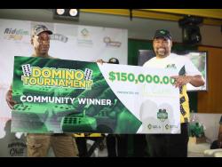 Supreme Ventures Limited  Executive Chairman Gary Peart (right) poses with Leroy Cooper, the Supreme Domino Master Series Champion of the May Pen Division, at Hotel Versalles in May Pen, Clarendon, on Sunday.