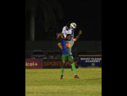 Montego Bay United’s Johann Weatherly (front) tries to block the header of Mount Pleasant’s Odane Murray during their Jamaica Premier League (JPL) football match at the Montego Bay Sports Complex in Catherine Hall on April 3. The match drew 2-2. 