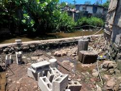 Residents of New Haven, St Andrew are building a wall to provide some security from the Duhaney River that flows by their community.