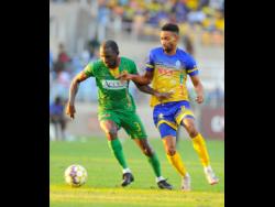 Timar Lewis (right) of Harbour View FC tackles Xavian Virgo of Humble Lion during their Jamaica Premier League quarterfinal second-leg match at Sabina Park on Monday.