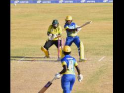 Barbados opener Aaliyah Alleyne plays a shot on her way to an unbeaten half-century against Jamaica Women in their third round T20 Blaze clash at Warner Park in St. Kitts yesterday. Wicketkeeper Natasha McLean looks on.