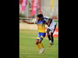 Jerome McLeary (right) of Cavalier tries to steal the ball from Timar Lewis of Harbour View during the Jamaica Premier League semi-final match at Sabina Park on Monday. Cavalier won 1-0.