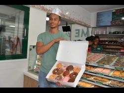 Adam Bogle, the first person in line when  Krispy Kreme opened its doors in Jamaica on Saturday, has won a year’s supply of Krispy Kreme’s original glazed donuts.