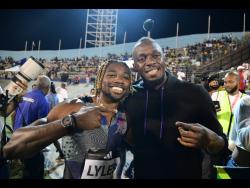 Winner of the men’s 200 metres at the Racers’ Grand Prix Saturday night at the National Stadium, Noah Lyles (left), celebrates his victory with world record holder Usain Bolt.