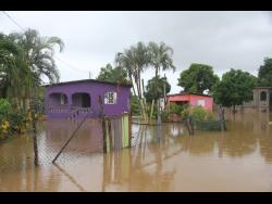 Residents of Spring Gardens Avenue, Savannah Cross in Clarendon tend to fear the rainy season due to the threat of flooding.