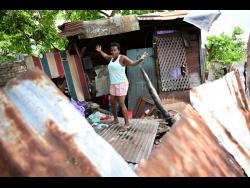 Pamela Hassock recounts the terrifying sight of a Jamaica Defence Force vehicle crashing into this house in Waterhouse on Friday.