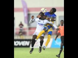 Harbour View’s Colorado Murray (right) gets a hand in the face of Cavalier’s Nickache Murray as they jump for the ball during their Jamaica Premier League (JPL) second-leg semi-final match at Sabina Park on Sunday. Cavalier won 2-0 to advance to the final 3-0 on aggregate.