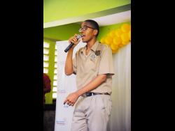 Kingston Technical High School student SeanJay Clarke deejays a song he wrote titled ‘Safer Internet’ about cyber safety, at the launch of the Safer Internet Project, at the school last Friday.