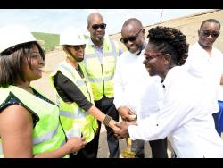 Fayval Williams (second left), minister of education and youth greets Beverley Harris (second right), principal of Bridgeport High School at the groundbreaking ceremony for the construction of a new classroom block. Looking on are (from left) Latoya Harris, executive director of the National Education Trust; Robert Miller, member of parliament for South East St Catherine; Leon Thomas, mayor of Portmore; and Dr Dane Levy, board chairman of the school.
