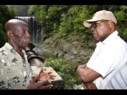 Minister of Tourism, Edmund Bartlett (right), in conversation with Reggae Falls CEO, Antonio Porter, during a destination assurance tour of the site last week.