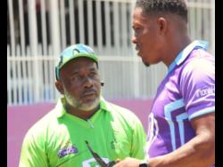 Surrey Kings’ coach Milton Thomas (left) chats with fast bowler Sheldon Cottrell after a Dream XI-sponsored Jamaica T10 match at Kensington Park yesterday.