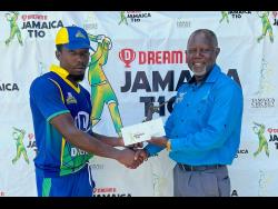 Middlesex United Stars batsman Suwayne Wilson (left) accepts his Man-of-the-Match award from Jamaica Cricket Association Cricket Operations and Development Manager, Oniel Cruickshank, after they defeated Middlesex Titans by nine wickets in the Dream XI sponsored Jamaica T10 competition at Kensington Park yesterday.