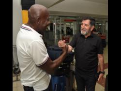 Former Reggae Boyz coach Brazilian Rene Simoes (right)  is greeted by Crenston Boxhill,  a former president of the Jamaica Football Federation, shortly after his arrival at the Norman Manley International Airport in Kingston yesterday.