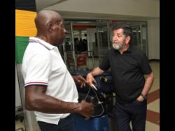 Former Reggae Boyz coach Brazilian Rene Simoes (right)  is greeted by Crenston Boxhill (left),  a former President of the Jamaica Football Federation (JFF), after Simoes arrived at the Norman Manley International Airport in Kingston on Tuesday. Simoes is on the island to participate in a football showcase in Manchester this weekend.