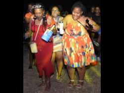 It was a family affair for Tracey Rutherford (left), granddaughter Elissa Patterson, and daughter Shantel Rutherford as they danced all night at the Reggae Sumfest Street Dance in Montego Bay on Monday.