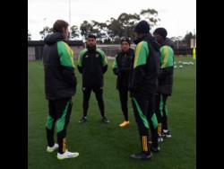 Reggae Girlz’s head coach Lorne Donaldson (second right), and assistant coach Xavier Gilbert (right) discuss tactics with performance coach Will Hitzelberger (left) and assistant coaches Ak Lakhani and Laurie Thomas during their training camp in Australia on Wednesday. The Reggae Girlz will face France in their World Cup opener on Sunday.