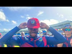 Kirk McKenzie beams with pride while putting on his West Indies Test cap on Thursday before debuting in the second Test against India at Queen’s Park Oval in Trinidad and Tobago.