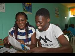 Credit: Contributed Training and placement coordinator at the Jamaica 4-H Clubs and summer camp coordinator, Bernetta Kerr (left), engages with National 4-H Boy of the Year, Ishmael Smythe, during this year’s staging of the camp at the Denbigh Showground in Clarendon from July 10 to 15.
