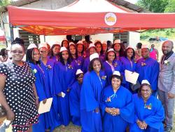 Beval Louis-Townsend (left) with Pastor Clayton Blake (right) and students. 