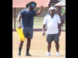 St Catherine CC’s Under-15 cricket coach Danza Hyatt (left) chats with his assistant, Milton Thomas.