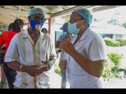 Minister of Local Government and Community Development, Desmond McKenzie (left), converses with Matron at the St Ann Infirmary, Alicia Drummond-Knight, during a tour of the facility last Friday.

 