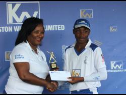 Simone Murdock (left), corporate services and client experience manager at Kingston Wharves Limited, presents Manchester U15 captain Demario Hall with one of his many awards following the team’s eight-wicket win over St Mary in the final of the Kingston Wharves Under-15 Cricket Championship at Up Park Camp on Friday.