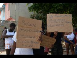 Residents of Denham Town in Kingston protest the killing of Nicholas Miller by members of the security forces yesterday.