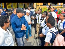 Prime Minister Andrew Holness speaking witht students of Kingston Technical High School last Friday.