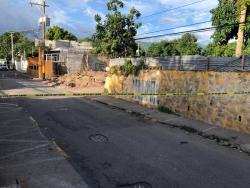 Police cordon off the scene in Shortwood Lane, Grants Pen, St Andrew, where two men were shot and killed yesterday afternoon.