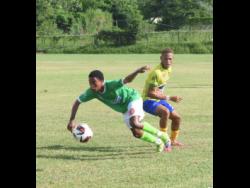 Frome Technical High’s Akeem Kongal (left) gets by Rusea’s High’s Davvaun Gibbon during the schoolboy ISSA/WATA daCosta Cup football match on Saturday at the Collin Miller Sports Complex in Lucea. Rusea’s won1-0.