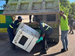 National Solid Waste Management Authority workers in action in Exchange, St Ann on Saturday.