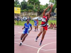 Glenmuir’s Brianna Nevers (right) goes high to receive a pass ahead of St Catherine’s Akeelah Lee during last season’s All Island netball final at Manchester High School in December. Glenmuir won 41-25.