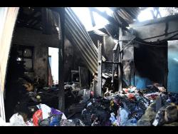 right: This house in Stony Hill, St Andrew was gutted by fire earlier this week.
