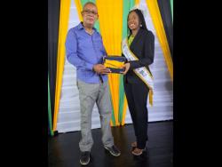 Miss Jamaica Festival Queen Aundrene Cameron accepting the Key to Spanish Town from Mayor Norman Scott. 