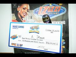 The newest Izizzi millionaire poses with her cheque after hitting the $4 million jackpot. 
