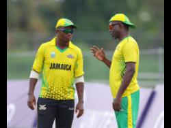 Jamaican Scorpions’ assistant coach Nikita Miller (right) chats with Andre McCarthy during their Super50 Cup game against the Barbados Pride recently.