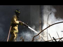 A firefighter carries out cooling-down operations at the Central Sorting Office last month.