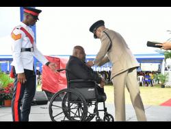 Commissioner of Police, Major General Antony Anderson (right),  presents Corporal Warren Francis with his medal of honour for long service and good conduct during an awards function held at the Police Officers’ Club in St Andrew on Thursday.