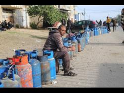 Palestinians line up for cooking gas during the second day of the temporary ceasefire between Hamas and Israel in Rafah, Gaza Strip, on Saturday. More than 13,300 Palestinians have been killed, roughly two-thirds of them women and minors, according to the Hamas-run health ministry in Gaza. More than 1,200 Israelis, mostly civilians, were killed in the initial attack, Israel said.