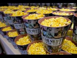 Popcorn in decorative containers is on display prior to the world premiere of the concert film ‘Taylor Swift: The Eras Tour’.
