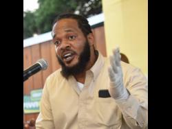 Kazrae Gray, who passed himself off as health inspector Randy Bucktoe, speaks at the reopening ceremony for the popular Crab Circle spot in Kingston last Thursday.