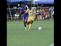 Waterhouse’s Keithy Simpson (right) shields the ball from Mount Pleasant’s Odane Murray during their Wray and Nephew Jamaica Premier League match at the Drax Hall Sports Complex in St Ann yesterday. The match drew 0-0.
