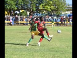 Treasure Beach’s Ramario Thompson (left) tackles Montego Bay United’s Brian Brown during their Wray and Nephew Jamaica Premier League match at the St Elizabeth High School (STETHS) Sports Complex in St Elizabeth yesterday. Montego Bay won 2-1.