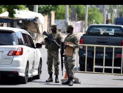Members of the security forces at a zone of special operation checkpoint in Greenwich Town, St Andrew. 