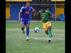 Mount Pleasant’s Sue-Lae McCalla (left) and Treasure Beach’s Jordan Nembhard are locked in a foot race to gain possession of the ball during their Wray and Nephew Jamaica Premier League match at STETHS Complex in St Elizabeth yesterday. Mount Pleasant won 2-0.