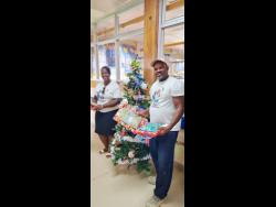 Rasheda and Jermaine Bailey show some of the toys that were presented to children at both the University Hospital of the West Indies and the Mandeville Regional Hospital before Christmas.