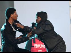 Dancehall artistes Fully Bad (left) and Honormosity tussle on stage during Sting. 