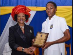 José Martí Technical High School student, Towain Christie, receives the Professor Verene A. Shepherd Award for History from Professor Shepherd. Occasion was the school’s 47th Founder’s Day Celebrations and Awards ceremony.