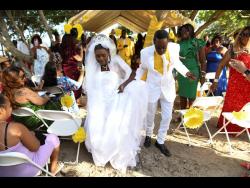 (Top Photo) Newly-weds Ephraim and Rena Manderson share a joyful dance on the picturesque beach in Prospect, St Thomas, symbolising the beginning of their journey together as man and wife.
(Bottom photo) Ephraim and Rena Manderson’s heart-warming union defies time.