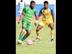 Vere United’s Deanandre Thomas (left) prepares for a challenge from Harbour View’s Ajuma Johnson during their Jamaica Premier League match at the Ashenheim Stadium yesterday. The match drew 0-0.